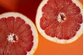 Sliced Ã¢â¬â¹Ã¢â¬â¹grapefruit on a orange background Royalty Free Stock Photo